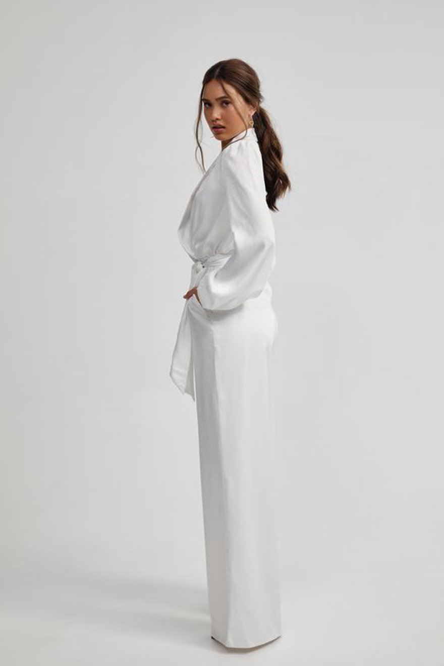 Model wearing Lexi Kesia ivory sandwash satin wide-leg jumpsuit showcasing the side