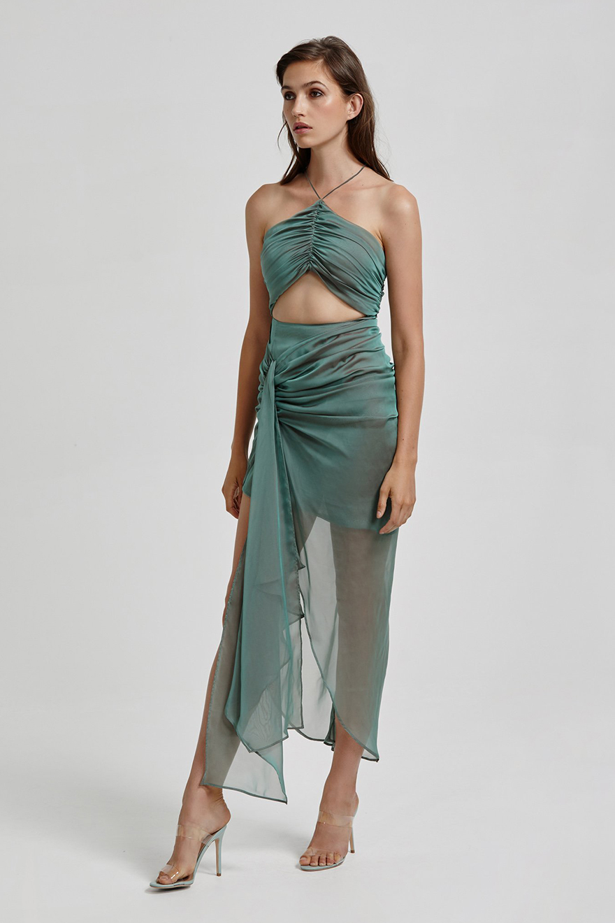 Model wearing Lexi Renata green shot chiffon cut-out dress with sheer split skirt looking to the side