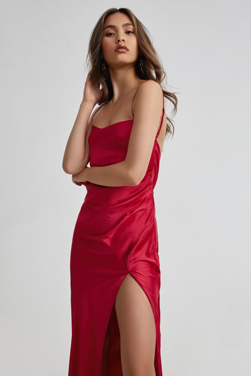 Model wearing Lexi Romy raspberry satin gown with thigh-high split and train