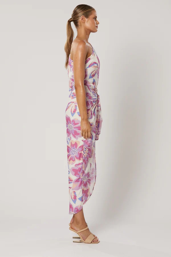 Model wearing Winona Audra lilac floral one shoulder wrap maxi with high split