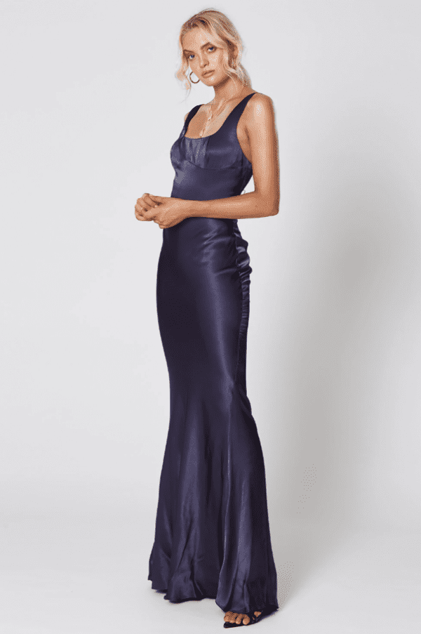 Model wearing Winona Lady of the Night navy satin fitted gown with fluted hem