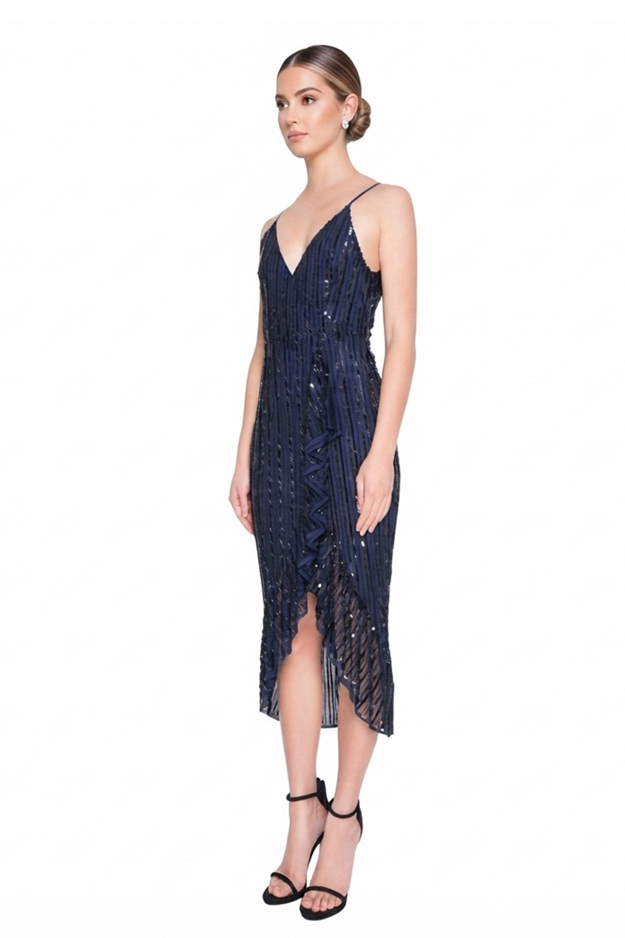 Model wearing Madame X Siyana navy striped sequin midi with ruffle hem