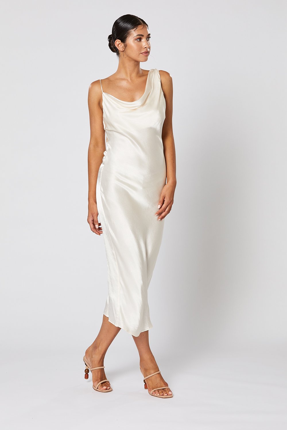 Model wearing Winona Cara pearl satin cowl neck midi dress on the right side
