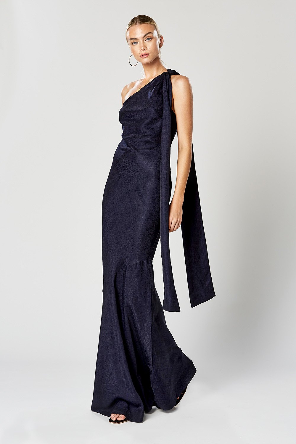 Winona Virtue navy one shoulder maxi gown with draped sash tie