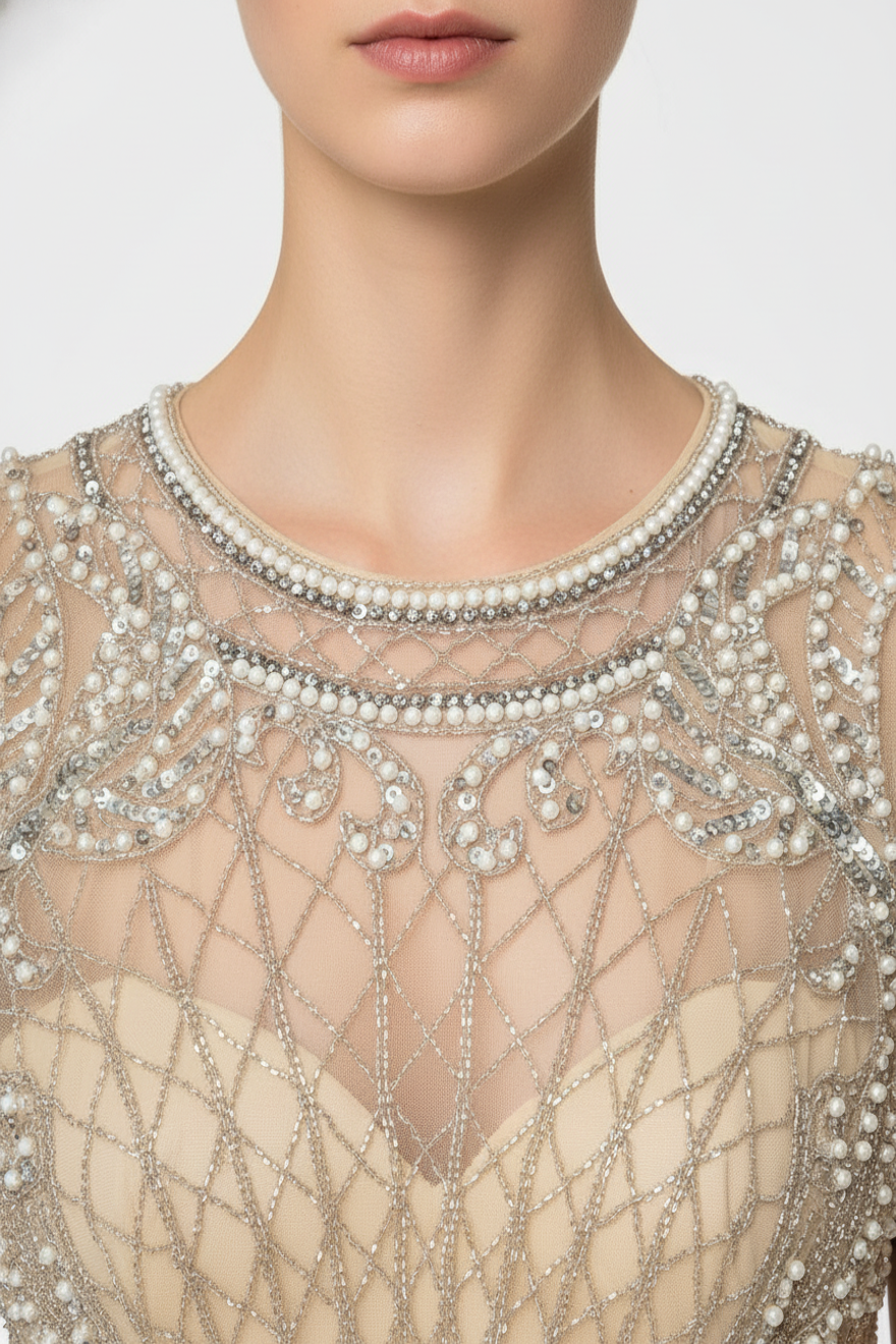 Close-up of pearl and silver beading on Atlazar champagne mesh mini dress