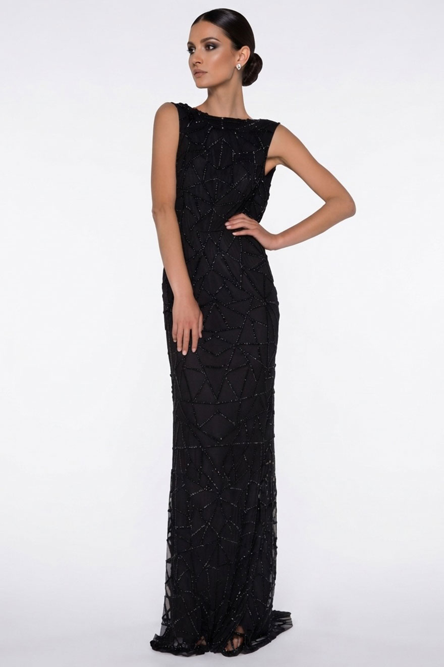 Model wearing Madame X Gracie black beaded column gown with sheer hem