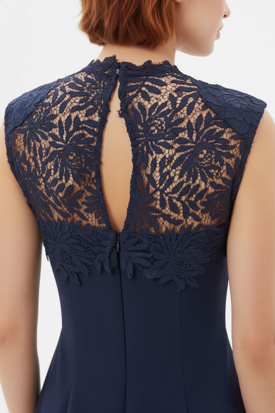 Close-up of floral lace hem panel on White Suede navy crepe dress